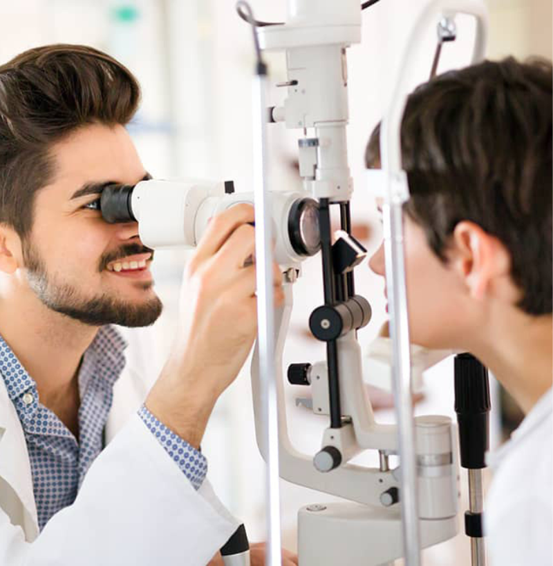 Doctor Examines patient's eye with the help of instrument in eye hospital Dubai